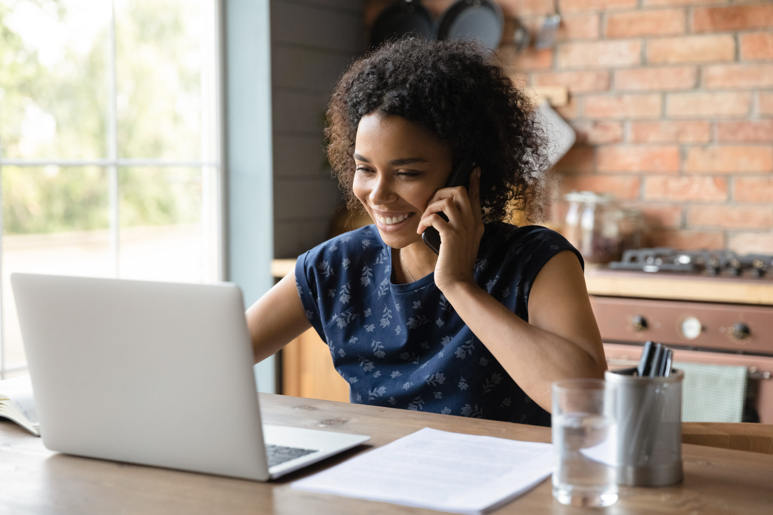 Close up happy African American woman making phone call