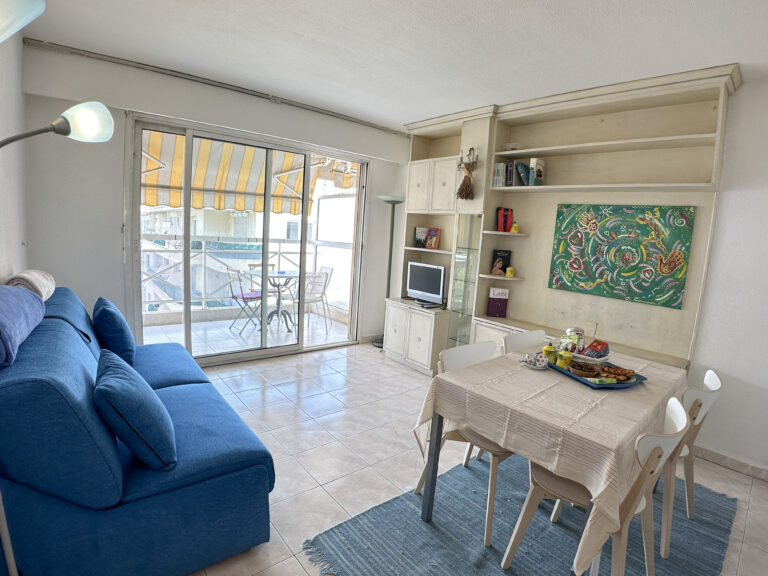 a living room with a blue couch and a table